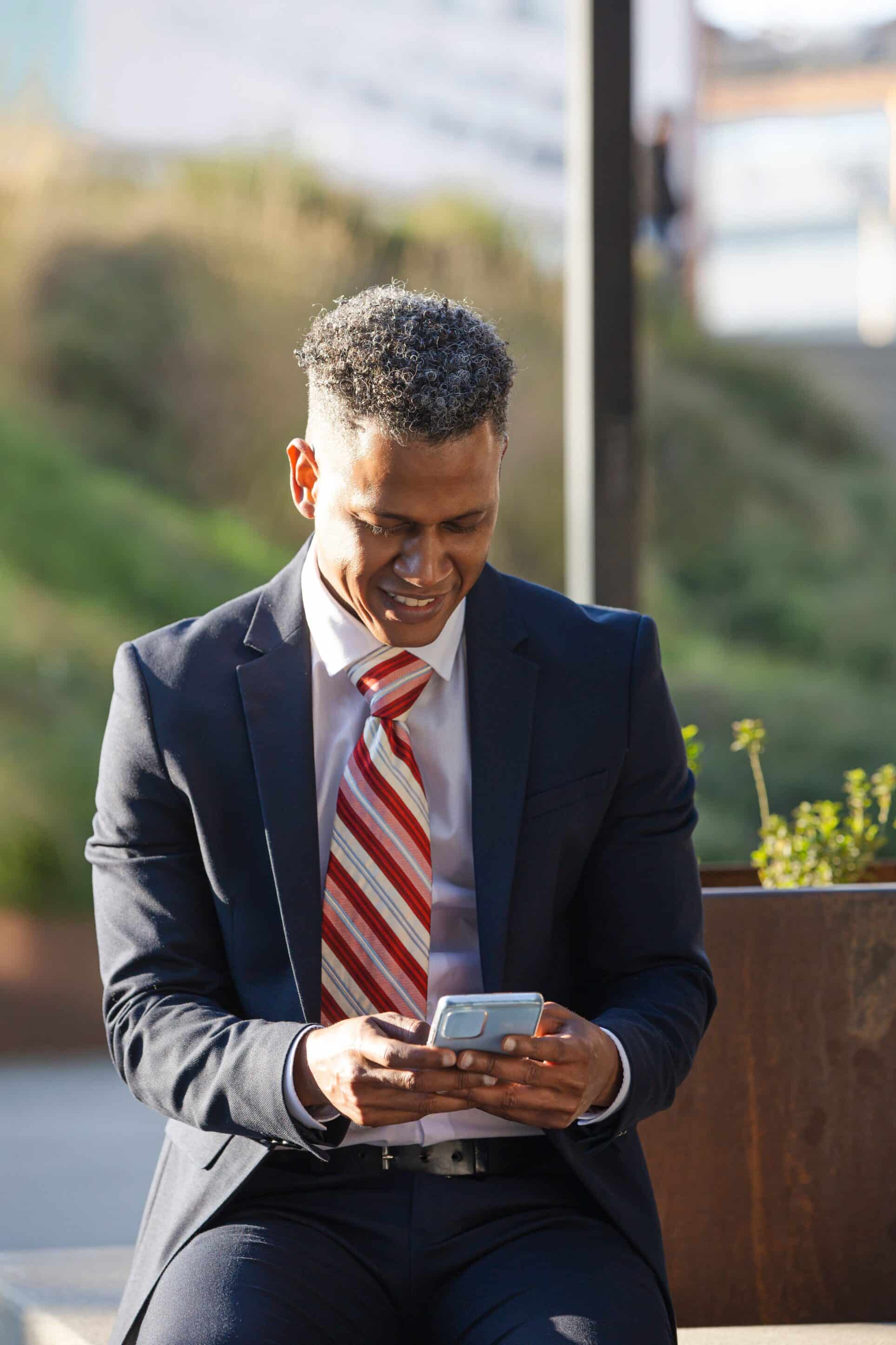 A young professional applying for a loan on his cell phone